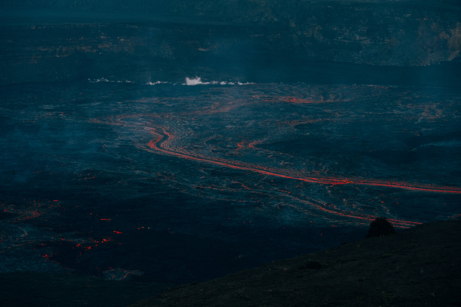 Bright orange lava flows cut through blue dusk. [Fuji X-T5 / Tamron 18-300]