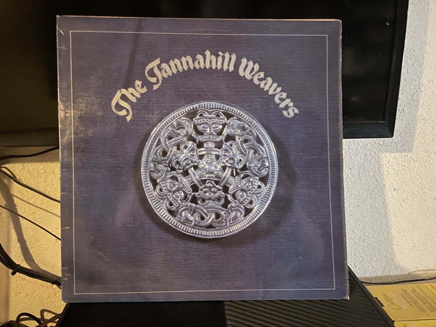 Sleeve of the self-titled Third Album by The Tannahill Weavers showing a silver buckle with knotwork representing a grotesque human figure.