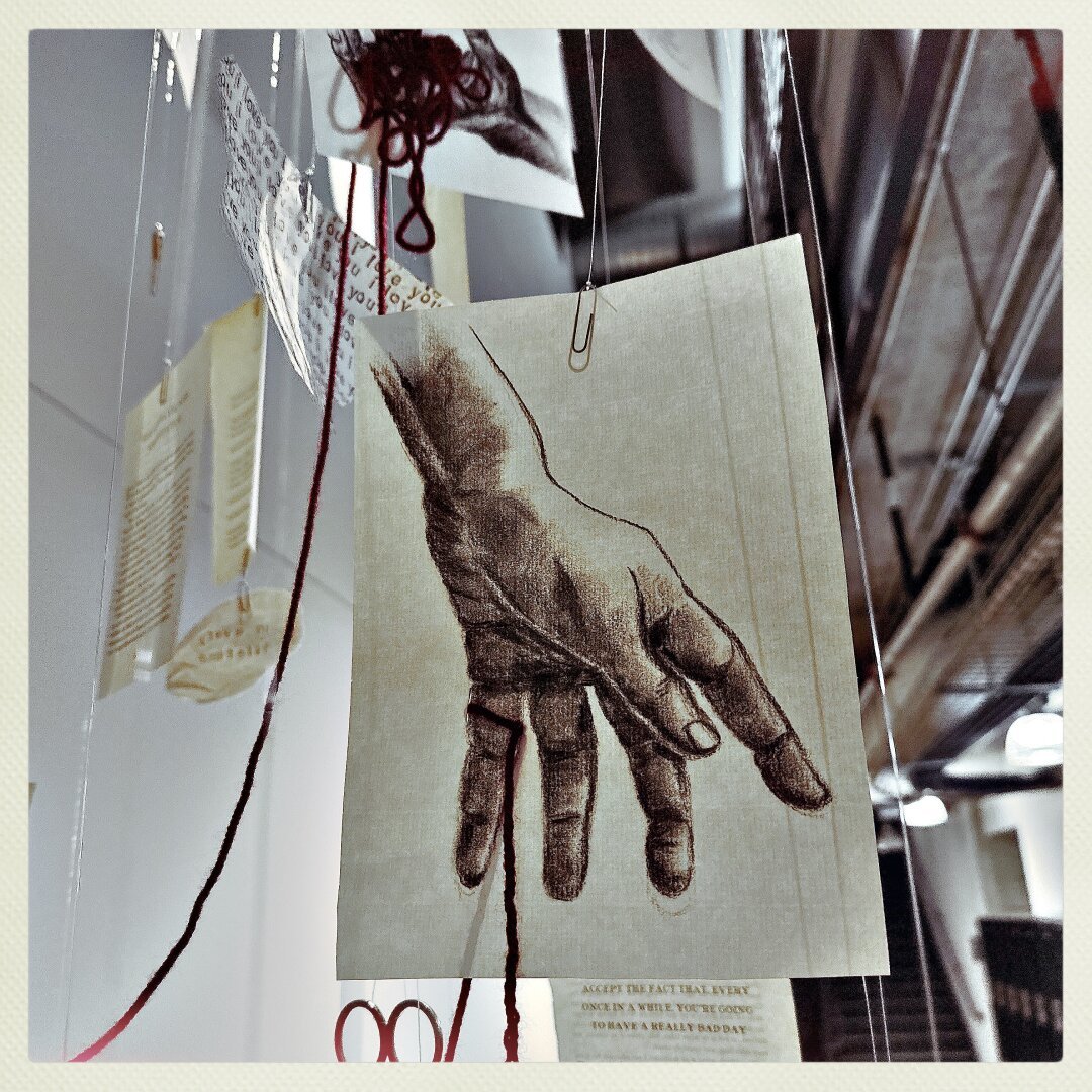 Picture of string and hand from the 2024 University of Minnesota Senior Art Show