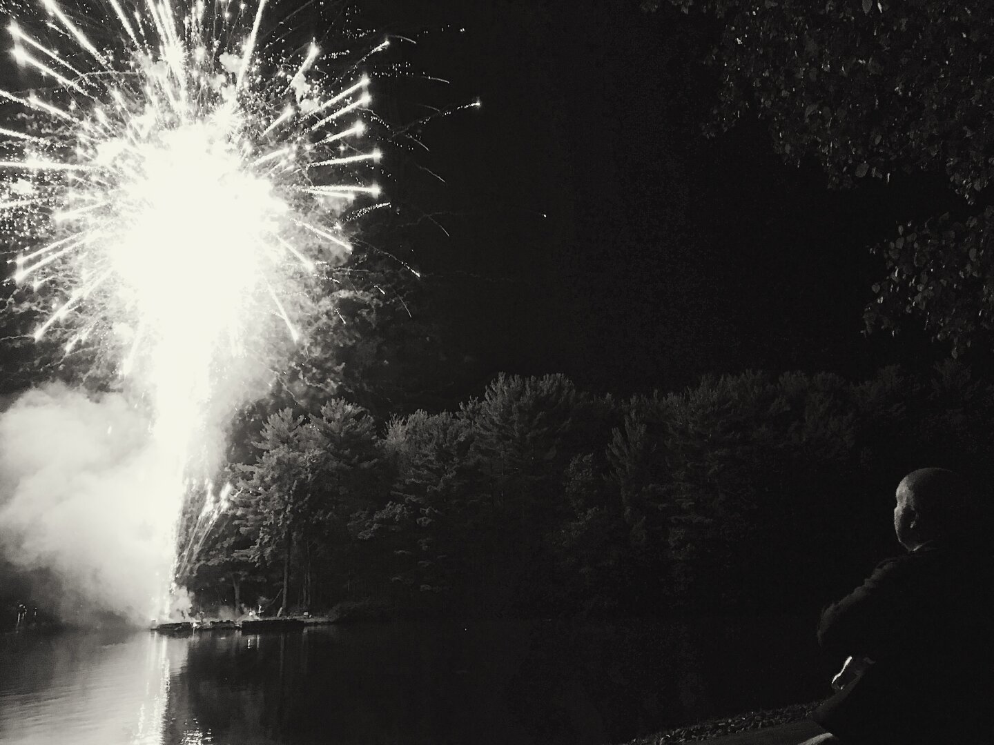 Man illuminated by fireworks