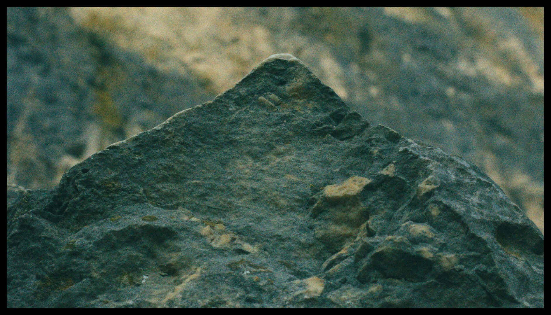 Same close-up photo of a triangular rock. Mostly unedited