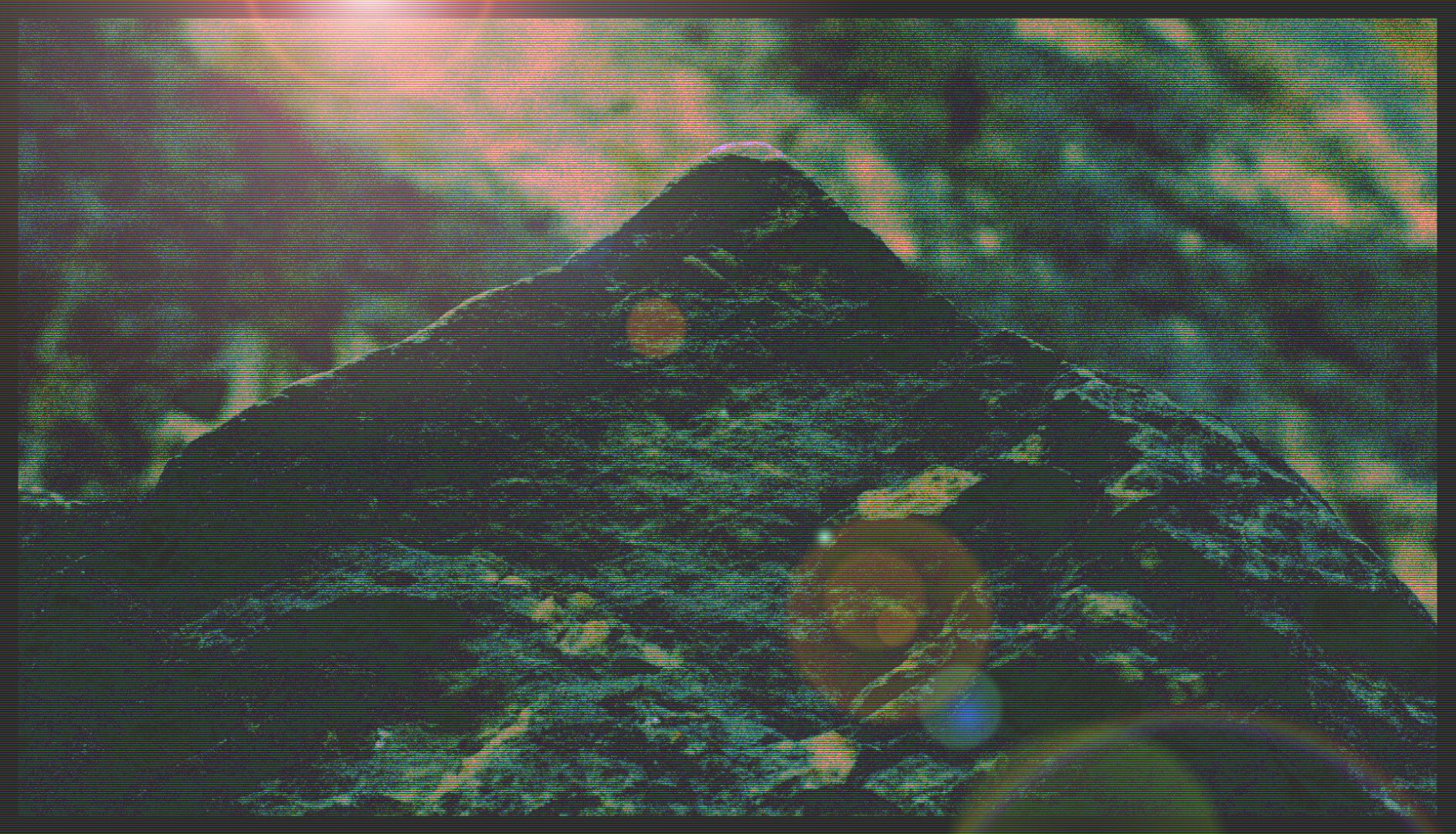 Same close-up photo of a triangular rock. Edited with TV-stripes and unrealistic colors and lens flare