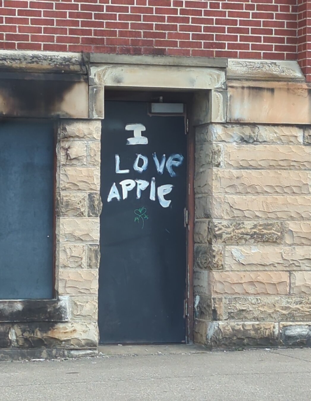 Graffitied church door that reads 