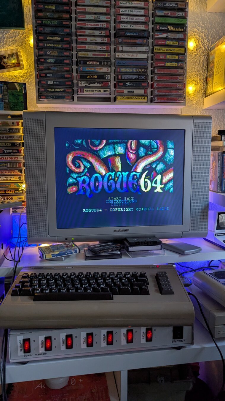 A table with my Commodore 64 running the game Rogue64