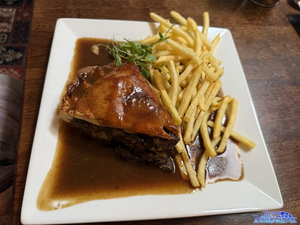 Homemade Steak & Ale Pie with chips, seasonal vegetables and gravy.