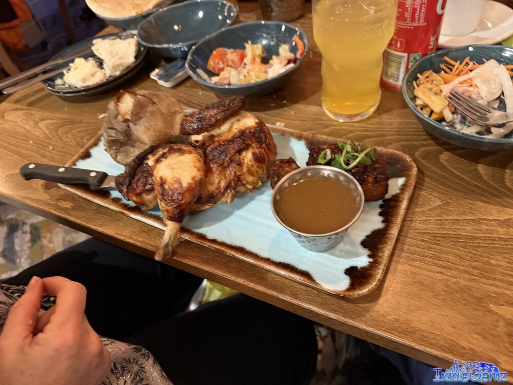 Half a rotisserie chicken with chicken gravy