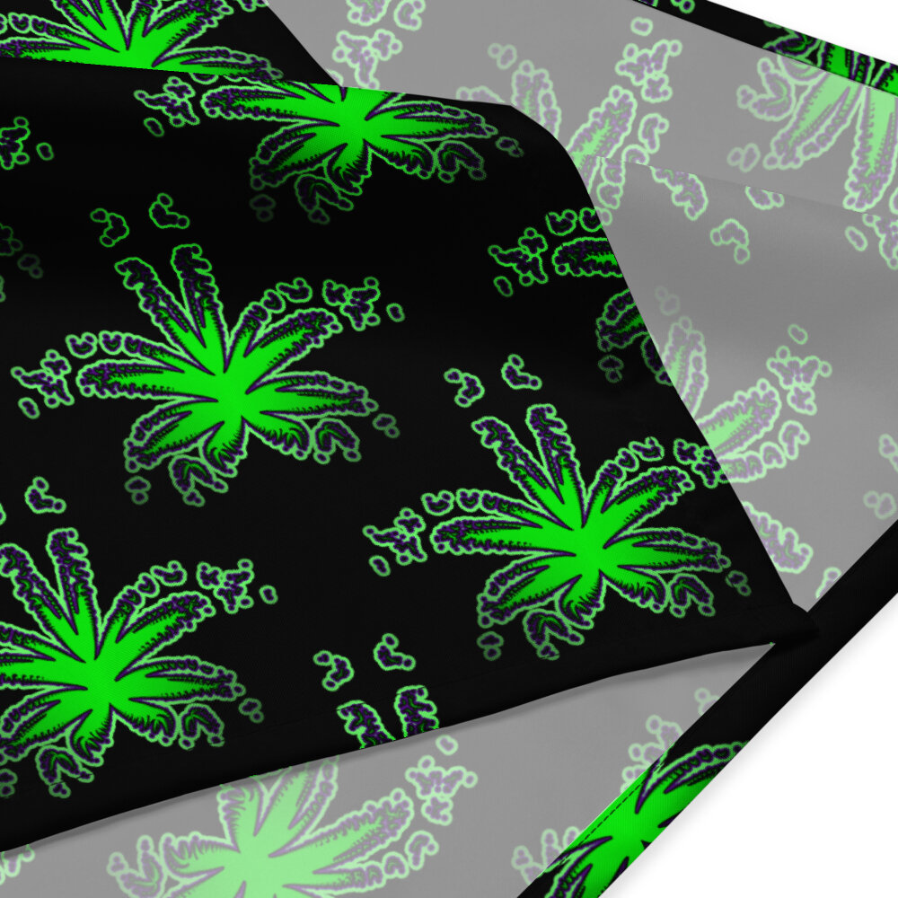 A closeup of the corner of a bandana that has a repeating pot leaf pattern. The weed leaves are bright green with a pruple outline, and the background is black.