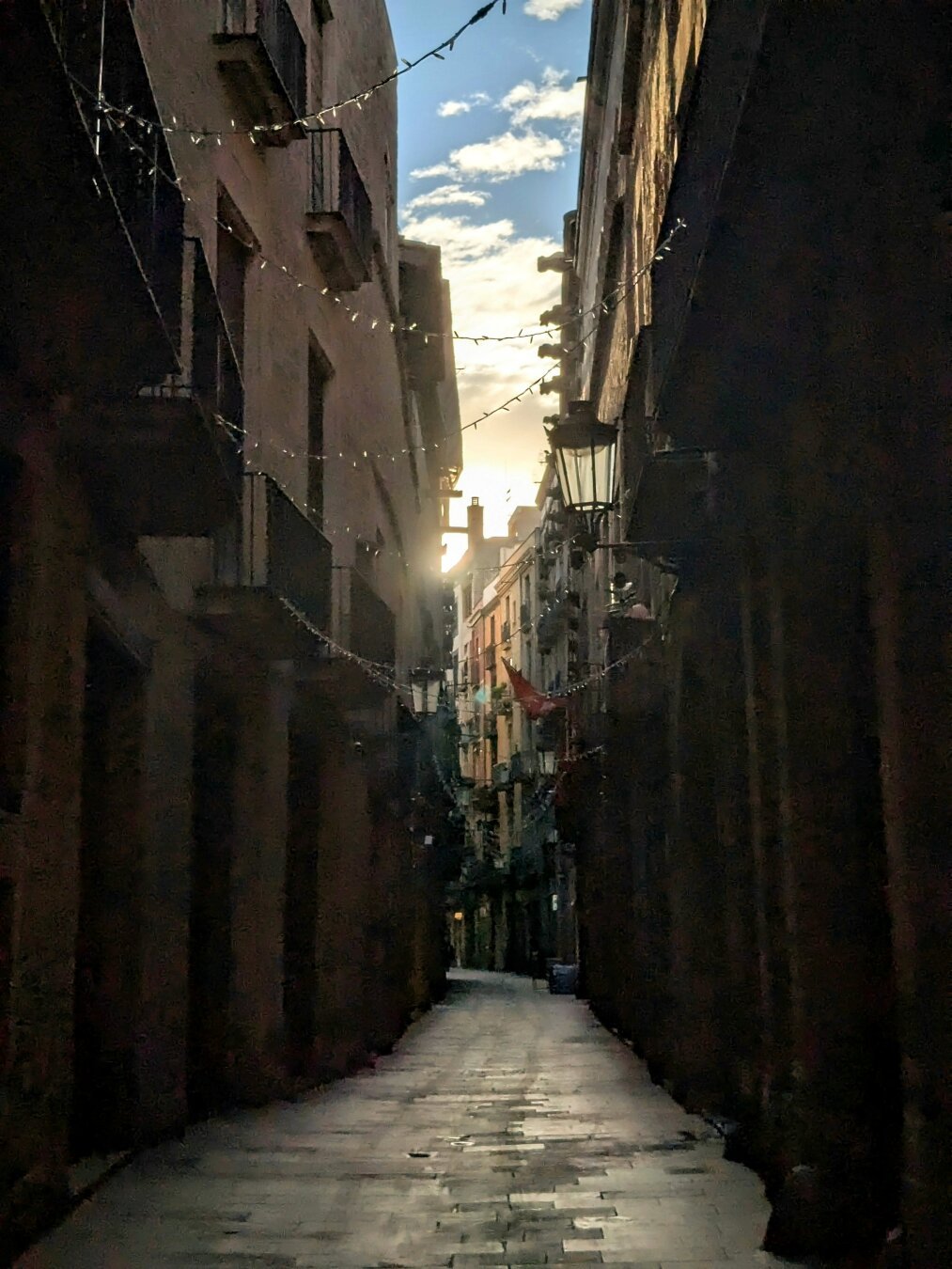 A sunrise seen from a narrow street in the El Born neighborhood in Barcelona