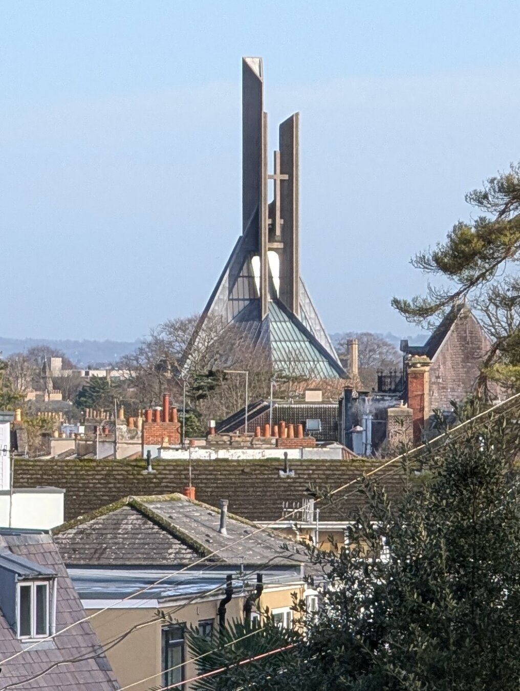 A picture of concrete church spires on a hazy blue day.