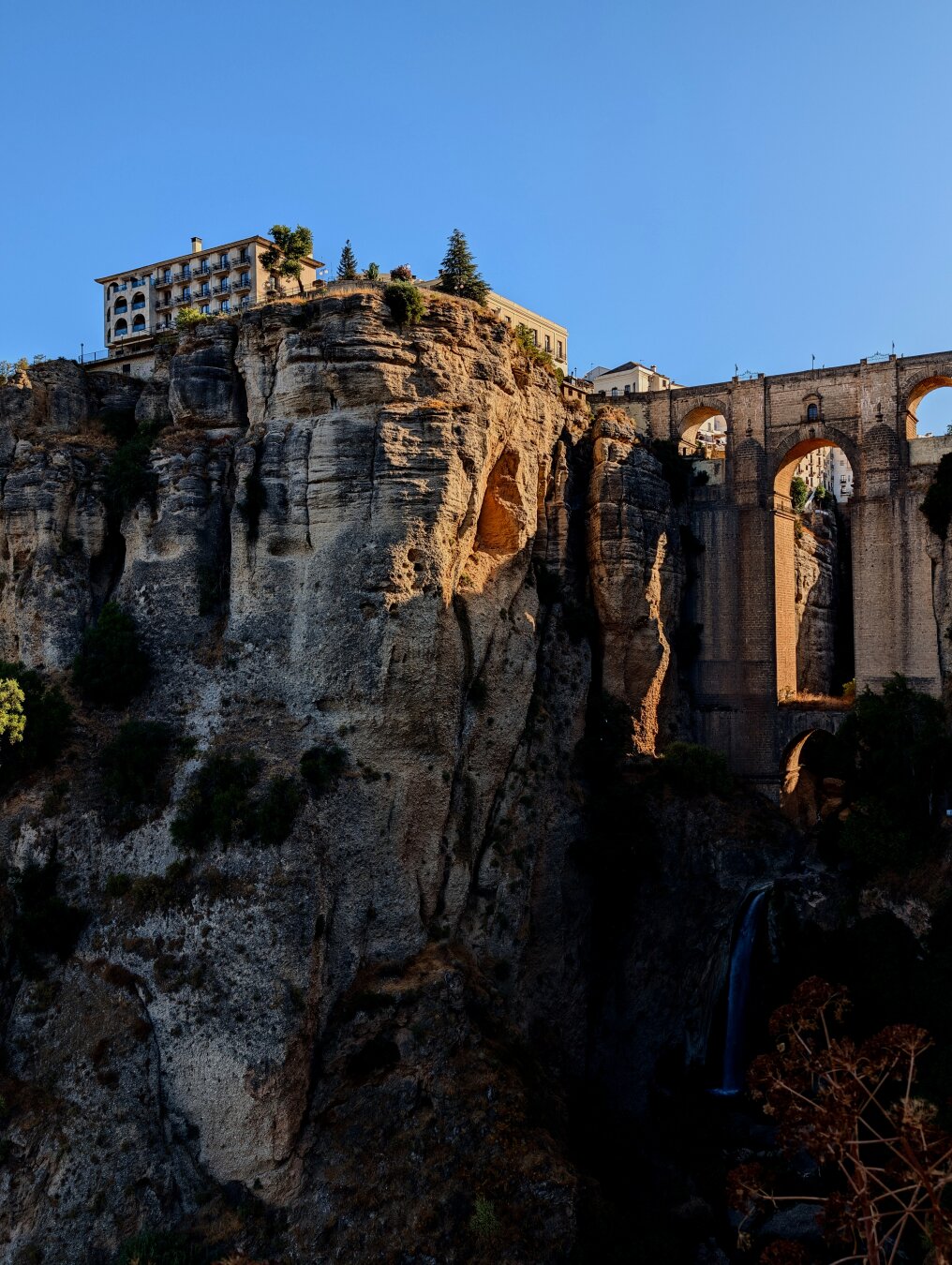 On the left the Parador of Ronda on the top of the rocks sleeping the city, on the right the Puente Nuevo of Ronda.