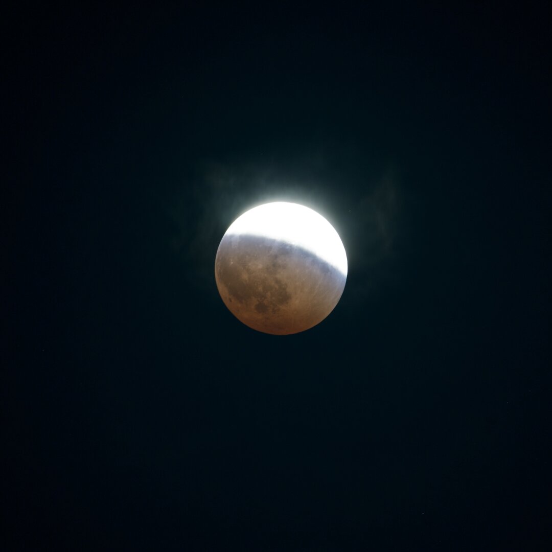 Full moon partially red due to the lunar eclipse