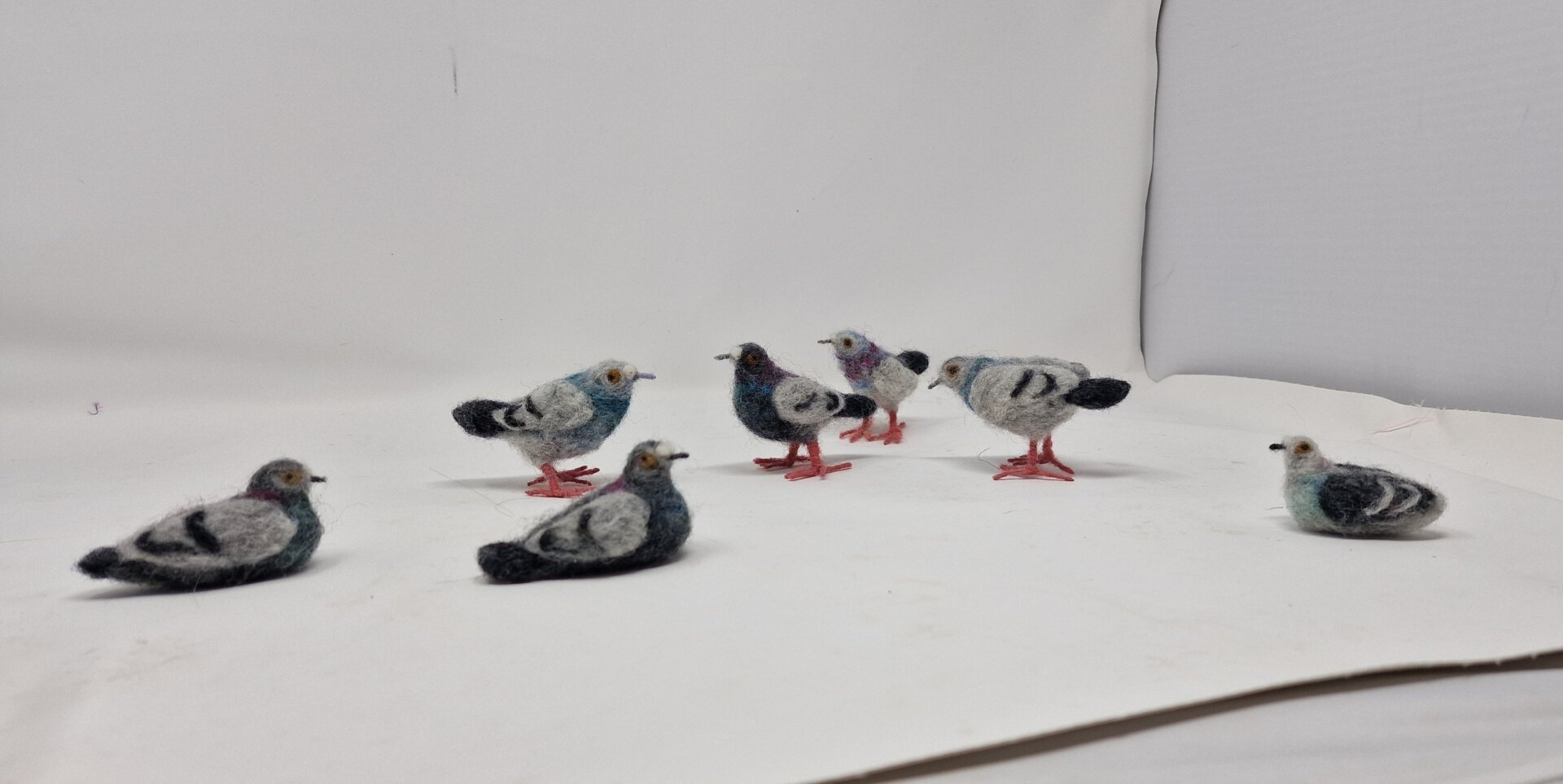 More felt pigeons in a light box