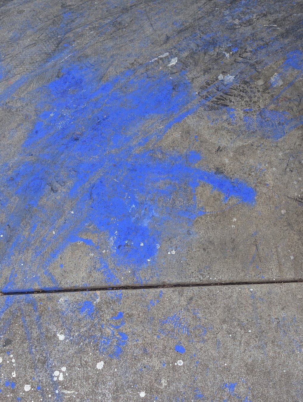 Blue chalk or paint in a remotely human-like form, diagonal smudged