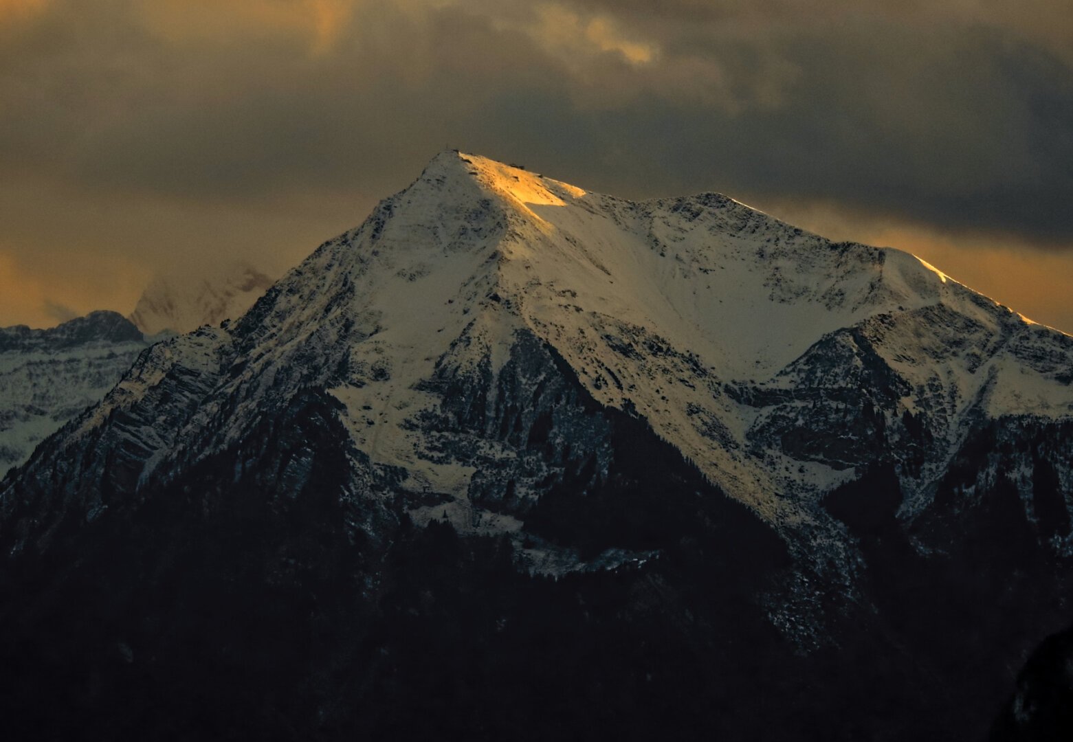 last golden light of the day hitting a mountain peak