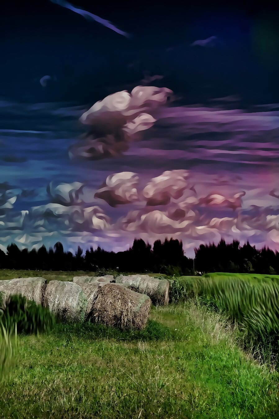 Huge round bales of hay in a field of tall green grass, the clouds and sky are an array of colors and look as if they are painted while the rest is photo-realistic