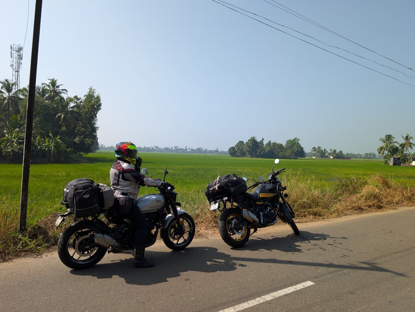 Dalma and motorcycles next to a rice paddy in Kerala.