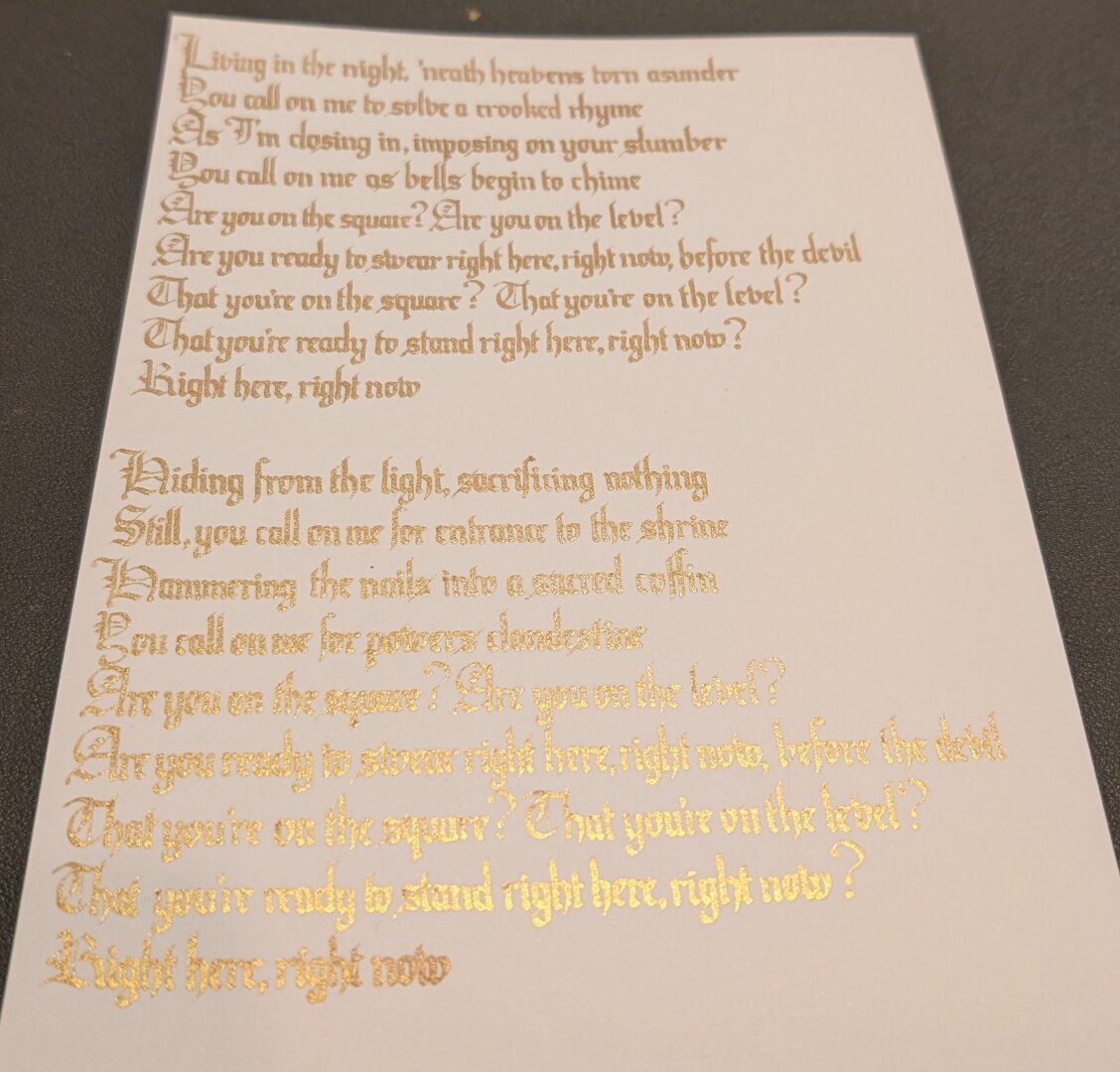 The same piece of calligraphy, photograph taken at an angle to show the reflective quality of the gold ink