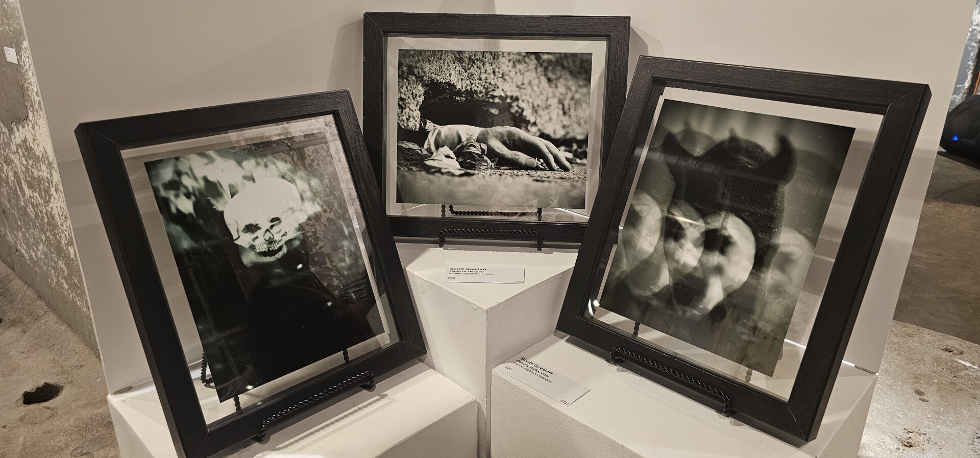1. Three framed photographs displayed in a museum setting, showcasing various artistic styles