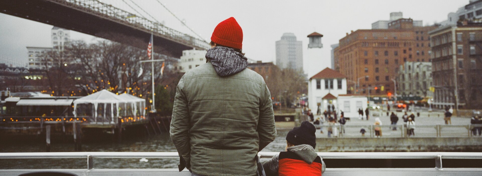 A father and son on a boat in front of DUMBO in New York City, shot on film