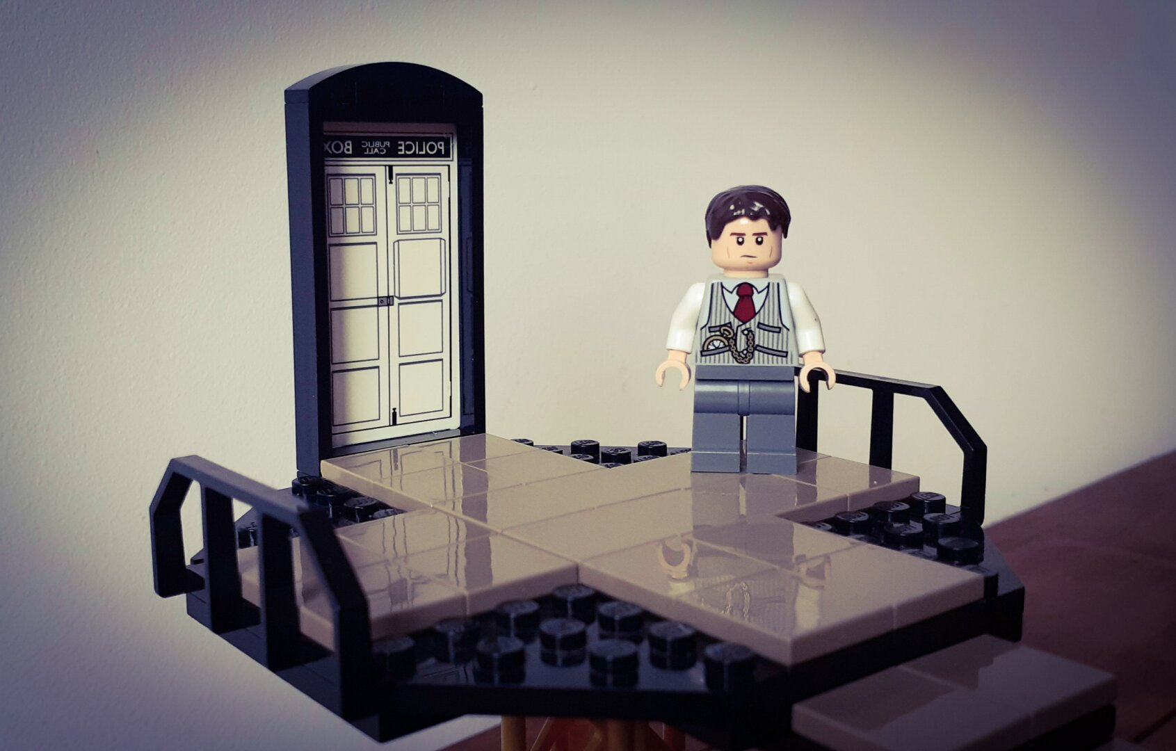 Bruce Wayne standing at the doors of the Bat TARDIS