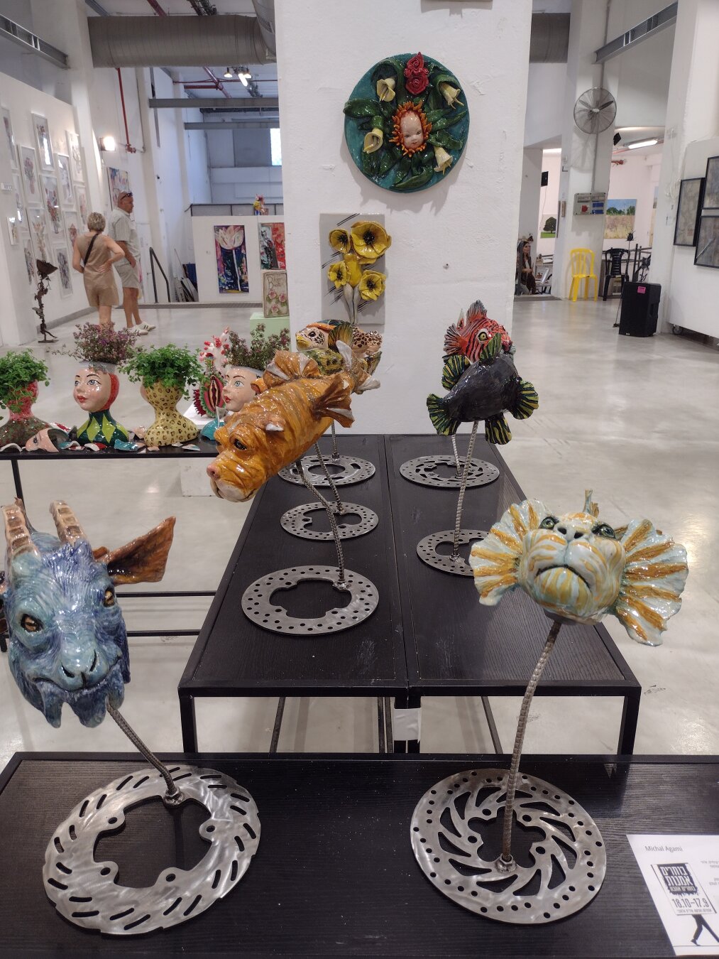A table with sculptures of fish with different animal heads