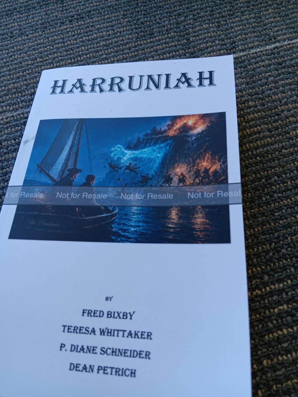 A white advanced-reader copy of the book "Harruniah" by Fred Bixby, Teresa Whittaker, P.Diane Schneider, and Dean Petrich.