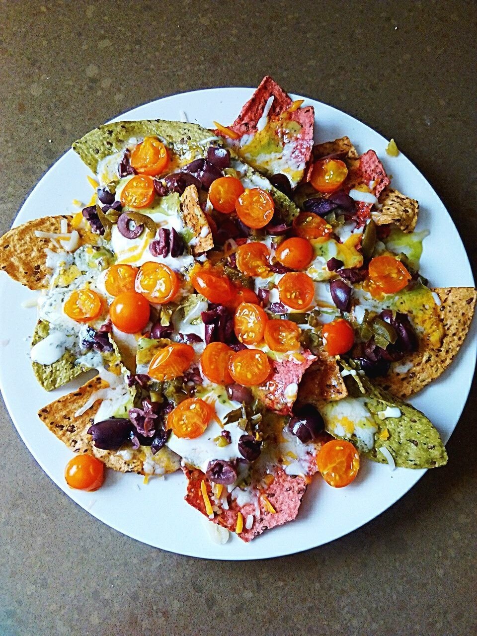 Plate of nachos made with colored chips.