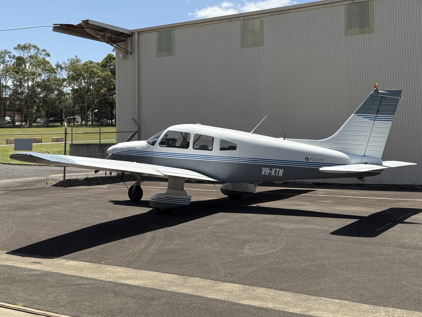 A white and grey Piper Archer aircraft