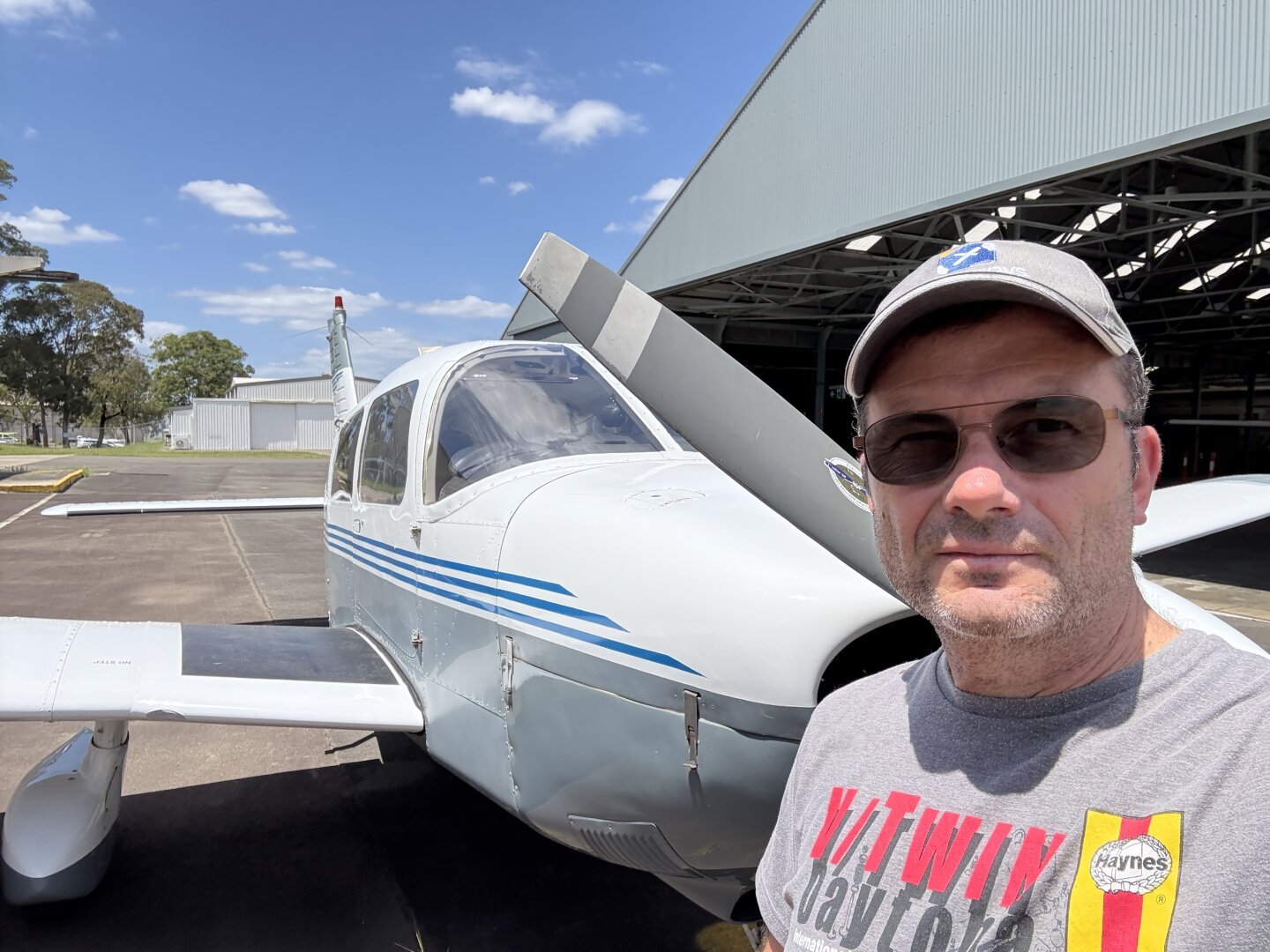 A pilot standing in front of a Piper Archer aircraft