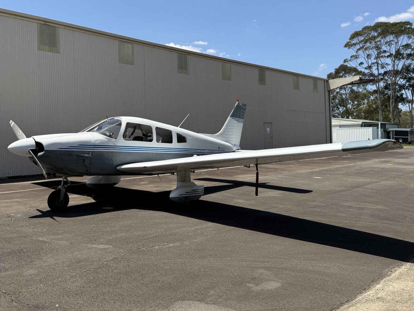 A white and grey Piper Archer aircraft