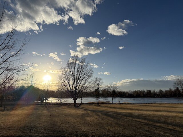 Shadow of a bike rider on a gravel path on a brown winter day in a Colorado park