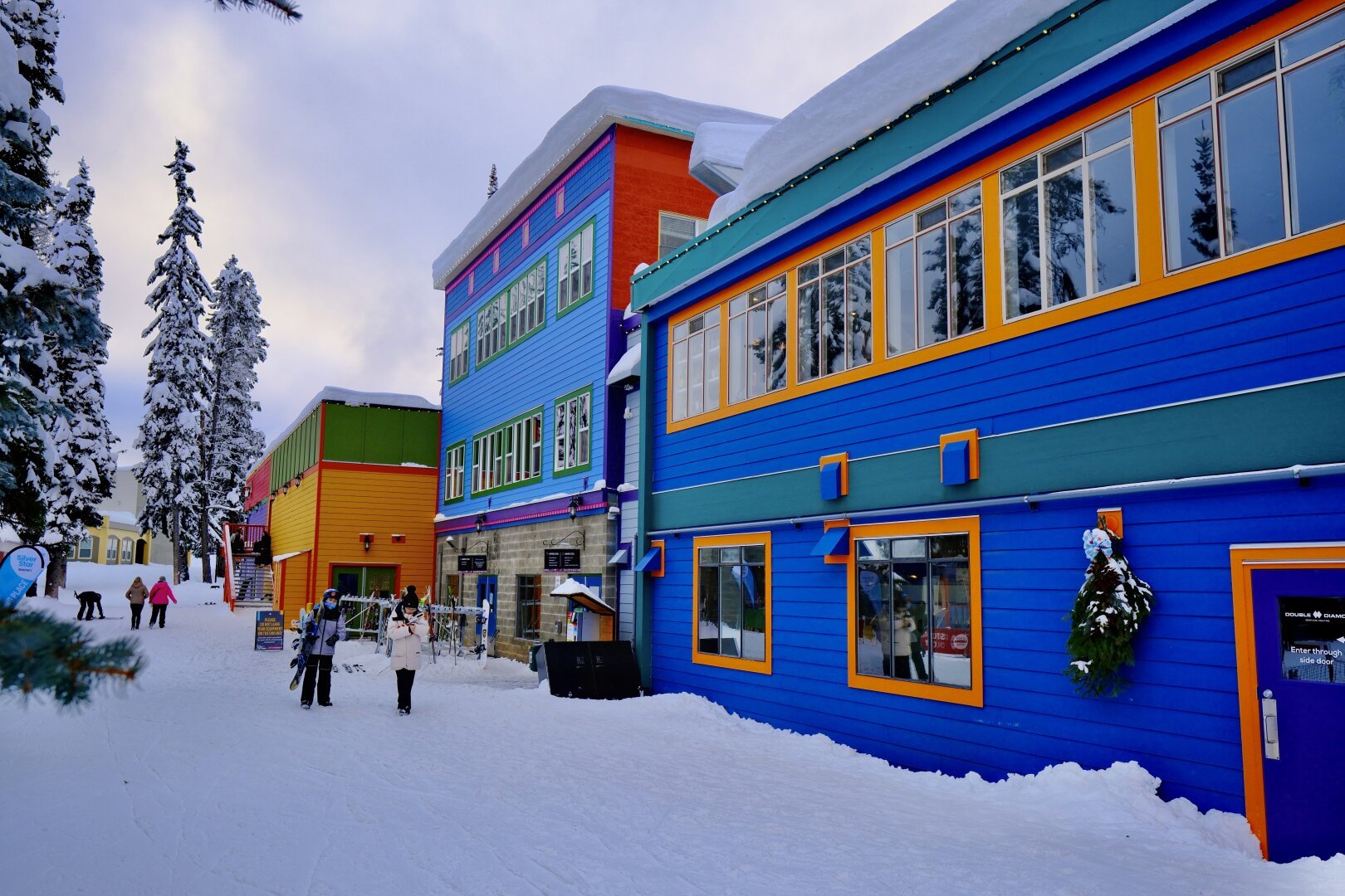 Photo of colourful buildings on snow.