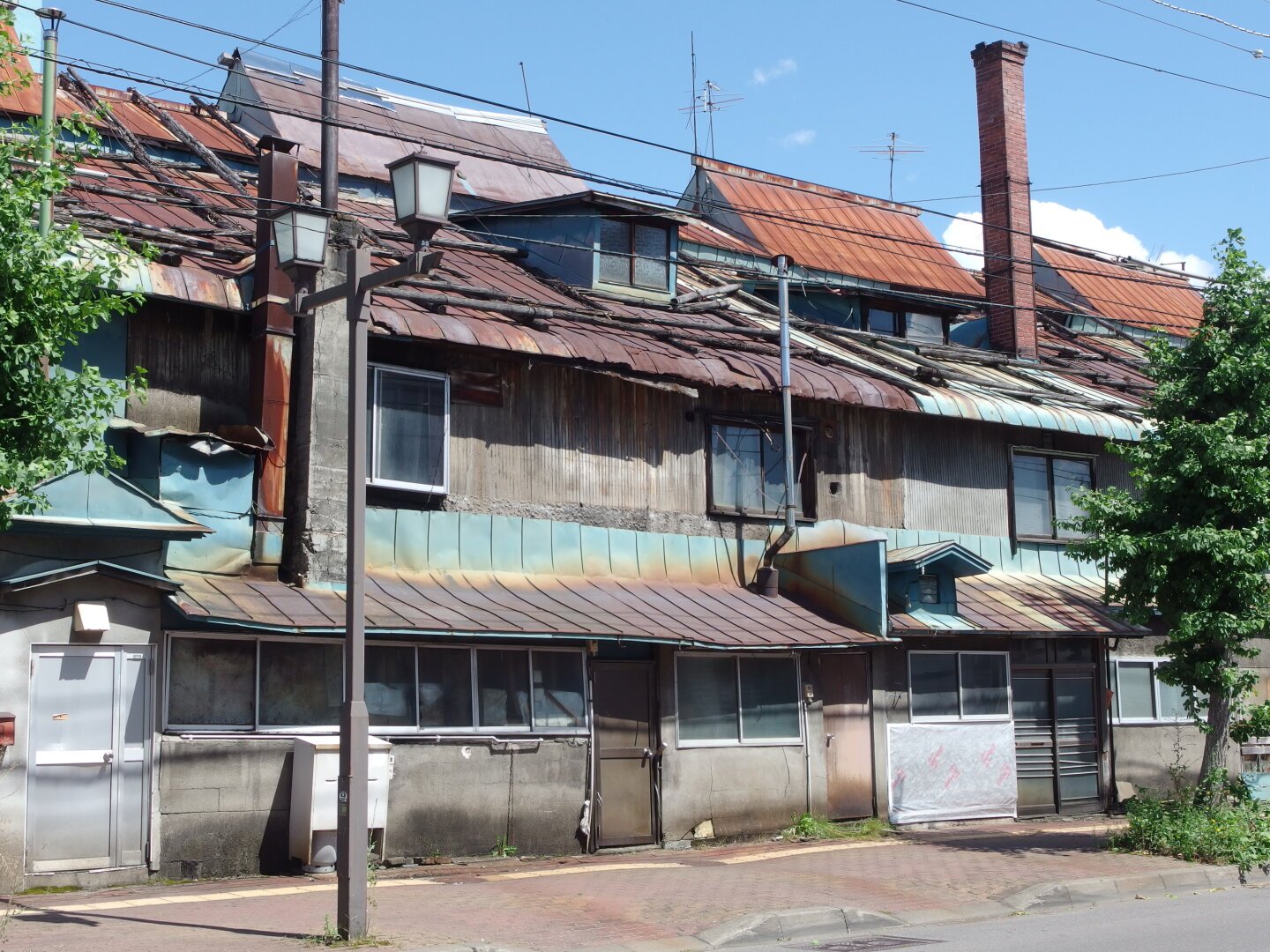 An old building in Japan with multiple small roofs and tons of jumbled up details.
