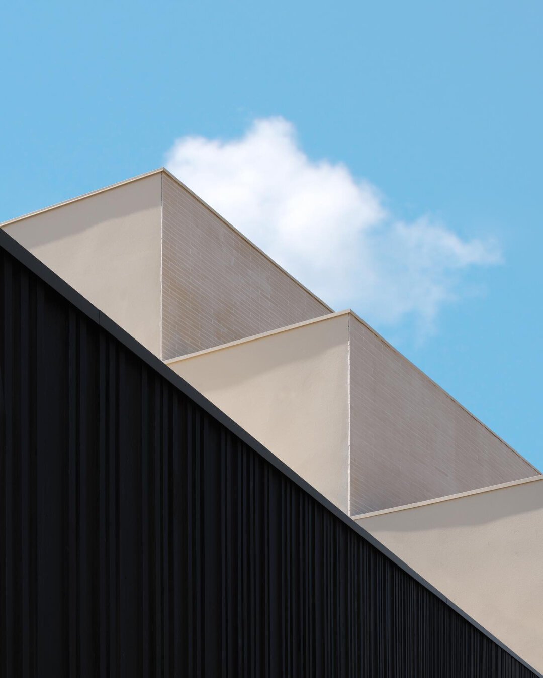 Architecture details, minimalist mood, contrasted textures and blue sky in the background