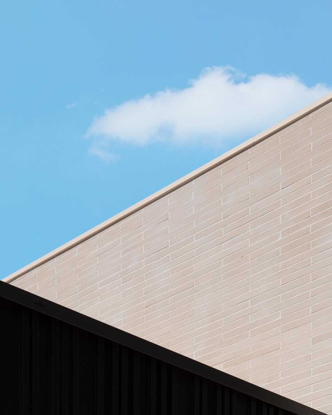 Architecture details, minimalist mood, contrasted textures and blue sky in the background