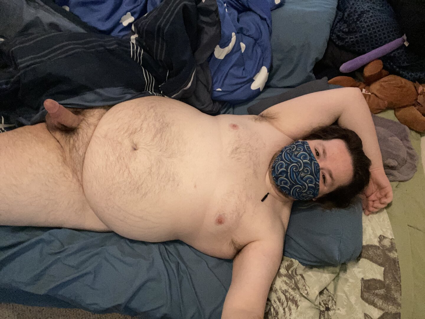 Silain laying naked in bed