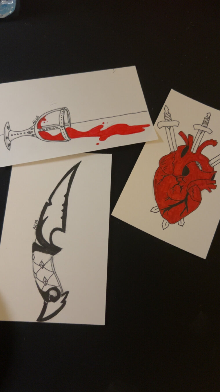 Spill features an ornate chalice whose body is made of both metal and glass, allowing the contents to remain visible. The chalice has been knocked on its side and bright red liquid is seen sloshing out. 
Knife features the ruined dagger from the first battle pass of riot games’ valorant, a team based pvp game. 
Pierce features the tarot card motif of the 3 of swords. An anatomically detailed human heart that is colored red is seen being pierced by three swords. One from the top, on from the top right and one from the top left. The ends of all of the swords can be seen coming out of the bottom of the heart as well.