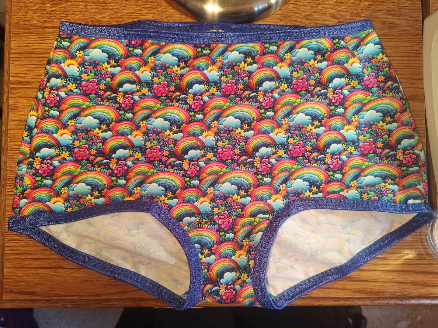 A pair of boy short underwear in a print that is mini rainbows all over