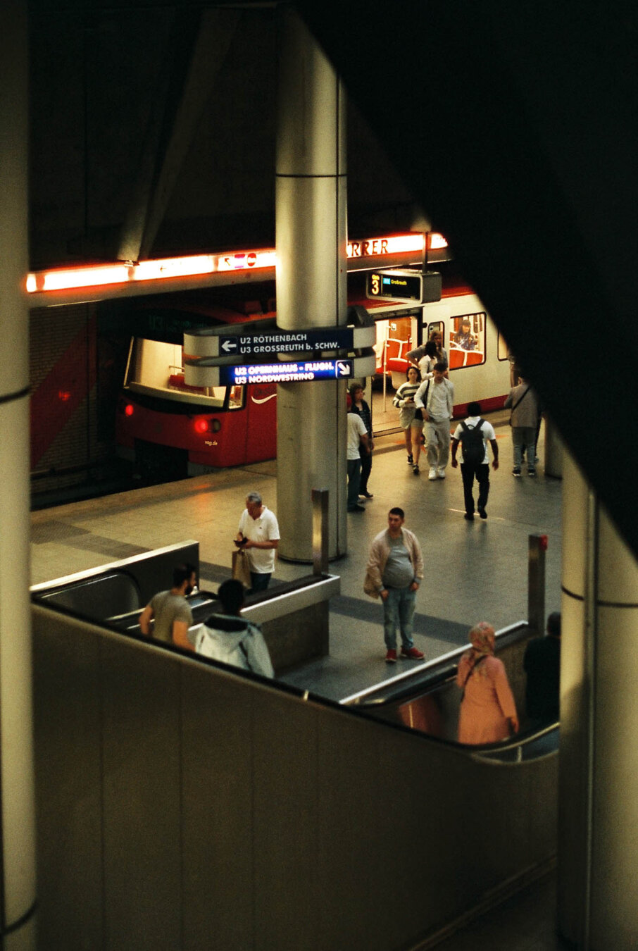 Film photo of the Plärrer U-Bahn station in Nuremberg, showing a busy scene of people entering or getting off the U-Bahn car.