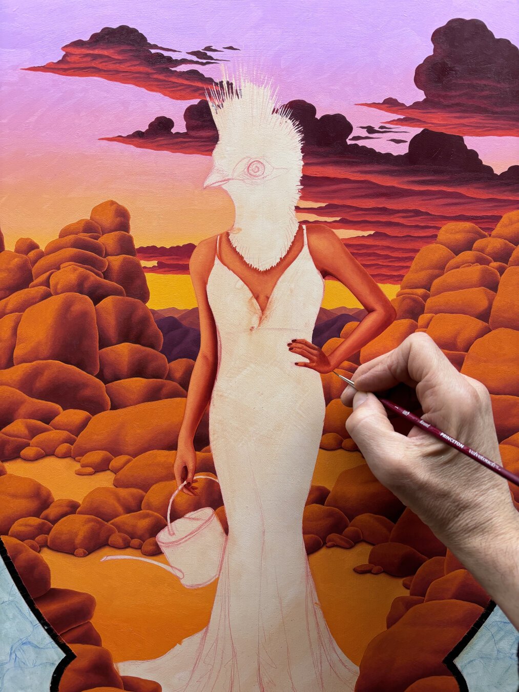 Oil painting in progress of a woman with a bird head, with sunset clouds over desert rocks and mountains in background