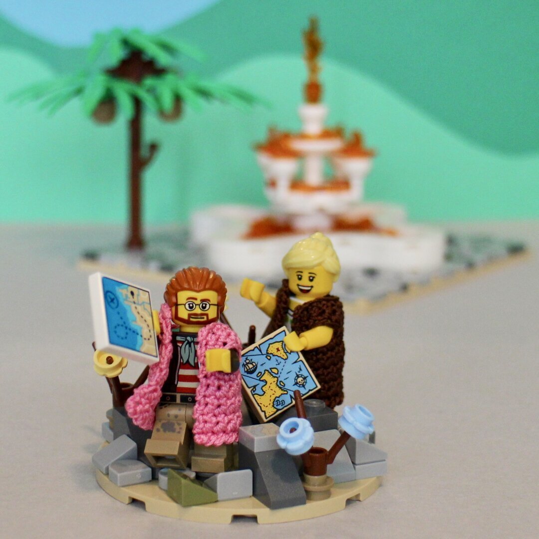 2 lego minifigures holding a map searching for the fountain of youth