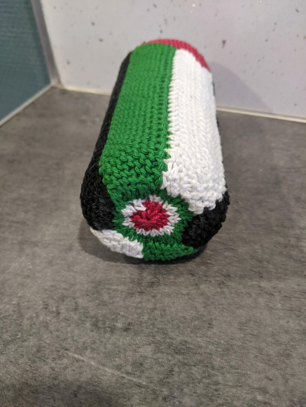 The bottom of the can cover. It’s has concentric circles of green and white with a red blob in the centre. It’s supposed to look like a sliced watermelon but it didn’t really work very well.