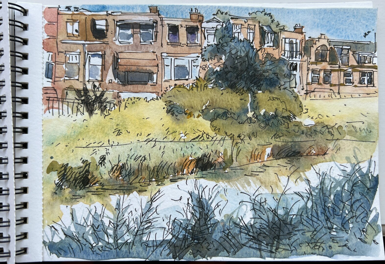 A page of a sketchbook containing a line art and watercolour sketch of the Houtrustweg in The Hague, Netherlands. Loose and colourful.