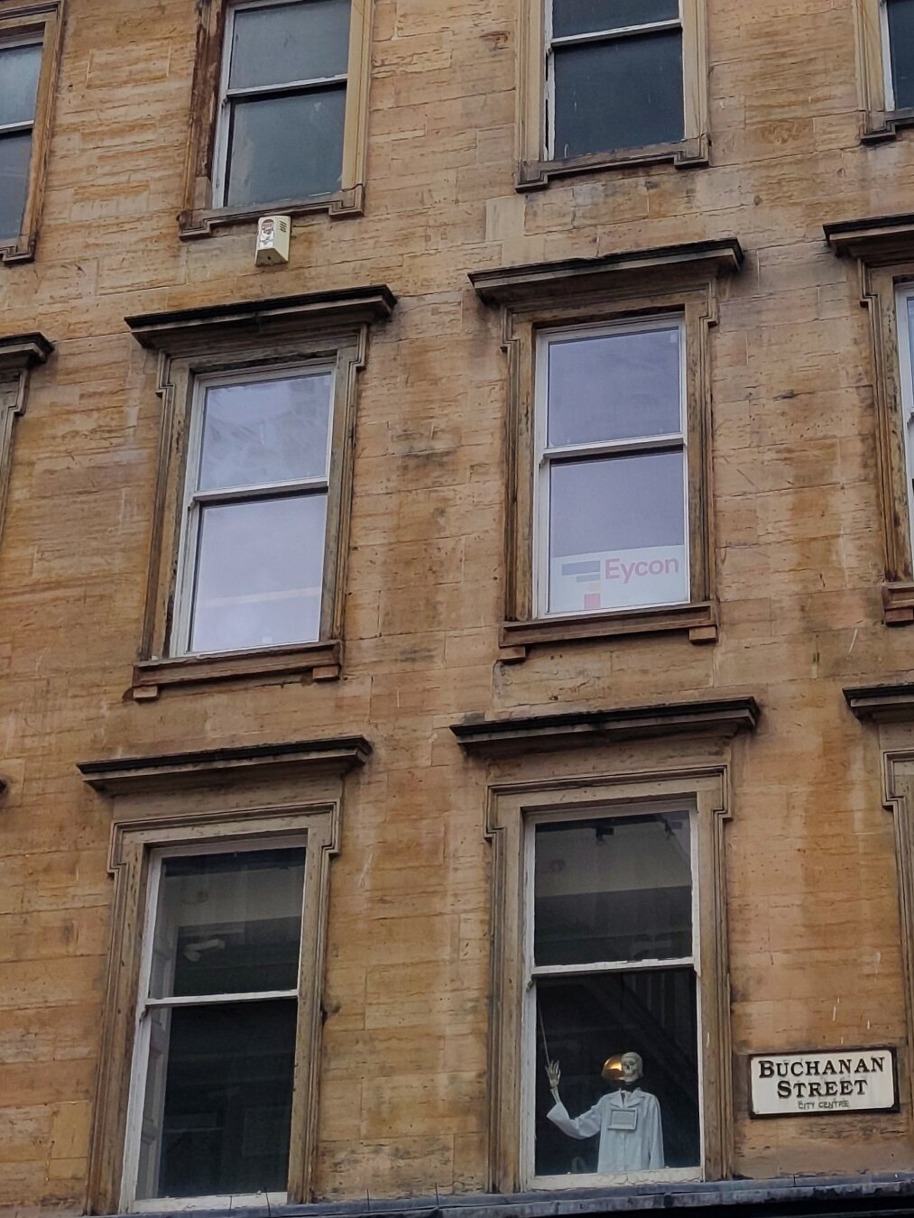 Skeleton at the window of a victorian building in glasgow