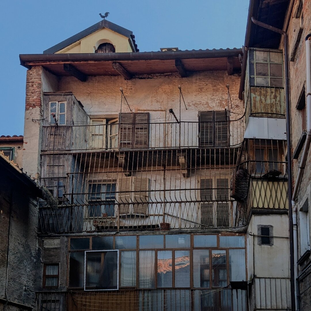 Old two storied house with rusted railings and windows