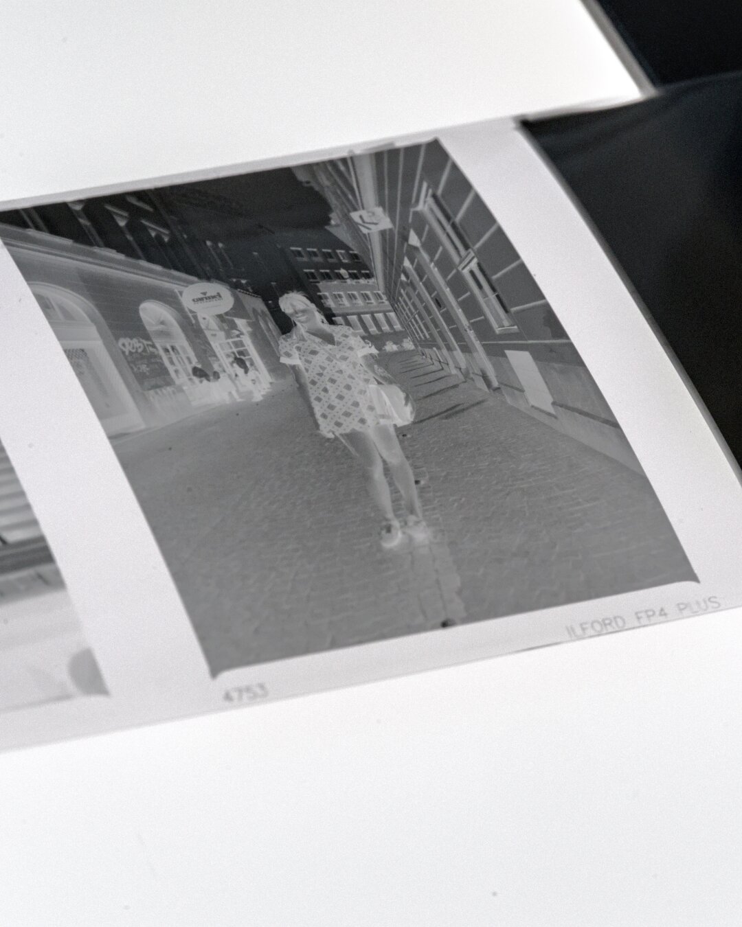 A photo of a medium format black and white negative. The film stock is Ilford FP4 Plus that can be read on the right left corner of the negative.