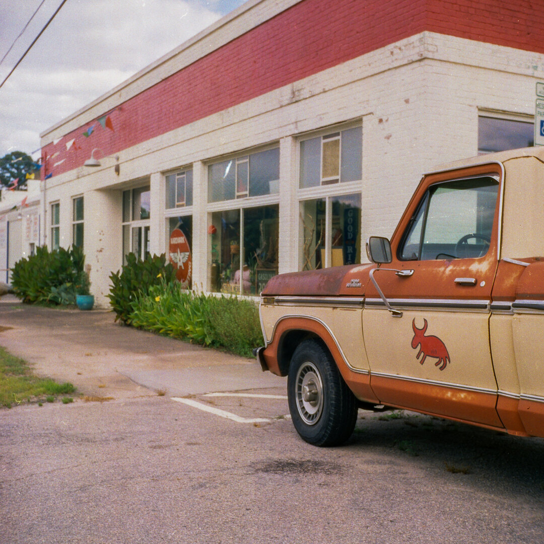 old Ford truck in front of building