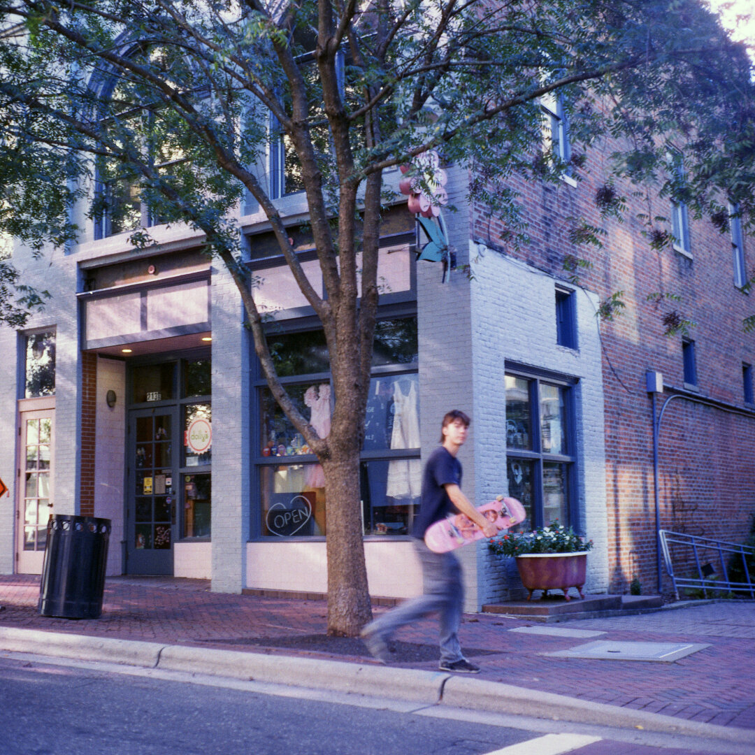 skateboarder in front of vintage store