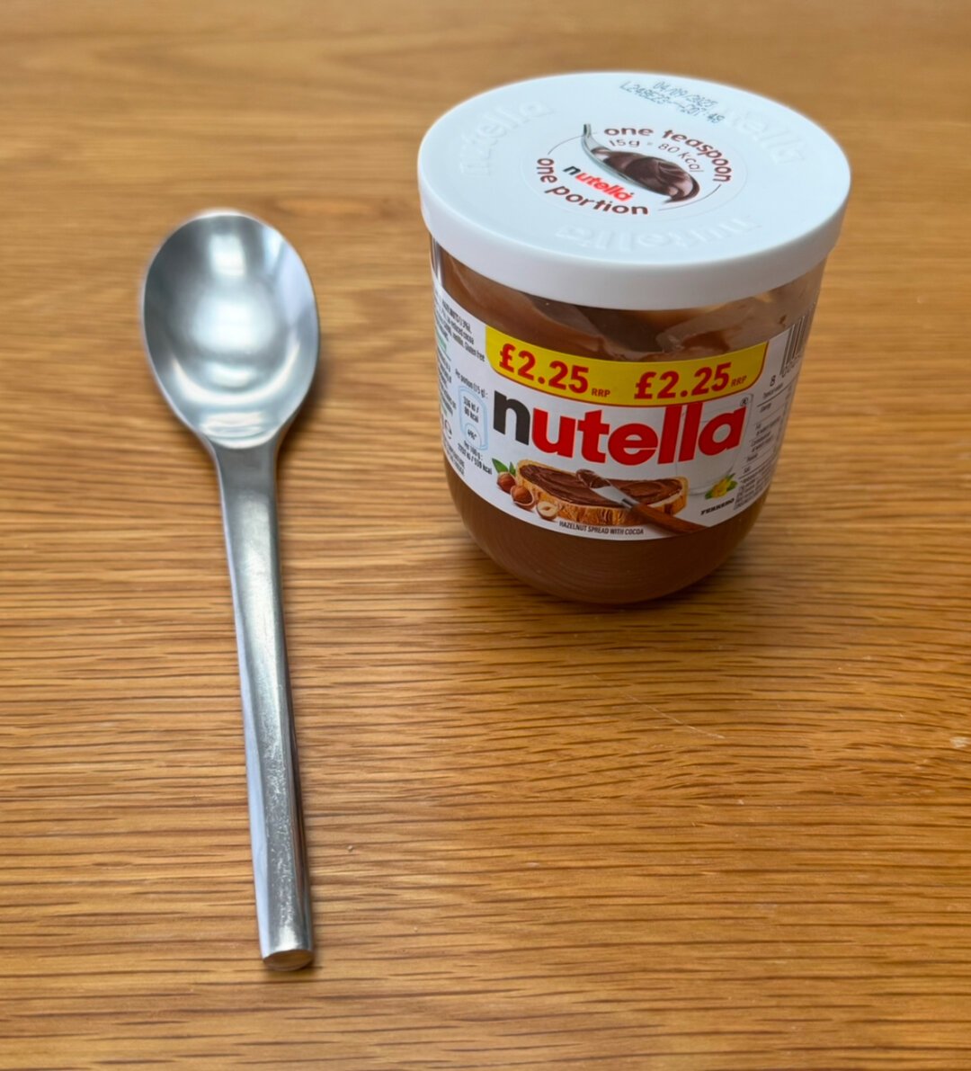 A spoon and a small jar of Nutella