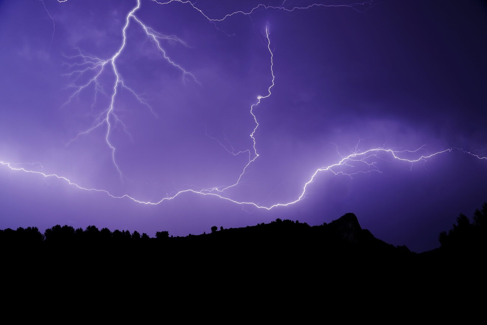 It's a photo of a huge lightning in south of France at night. The sky is blue mauve.